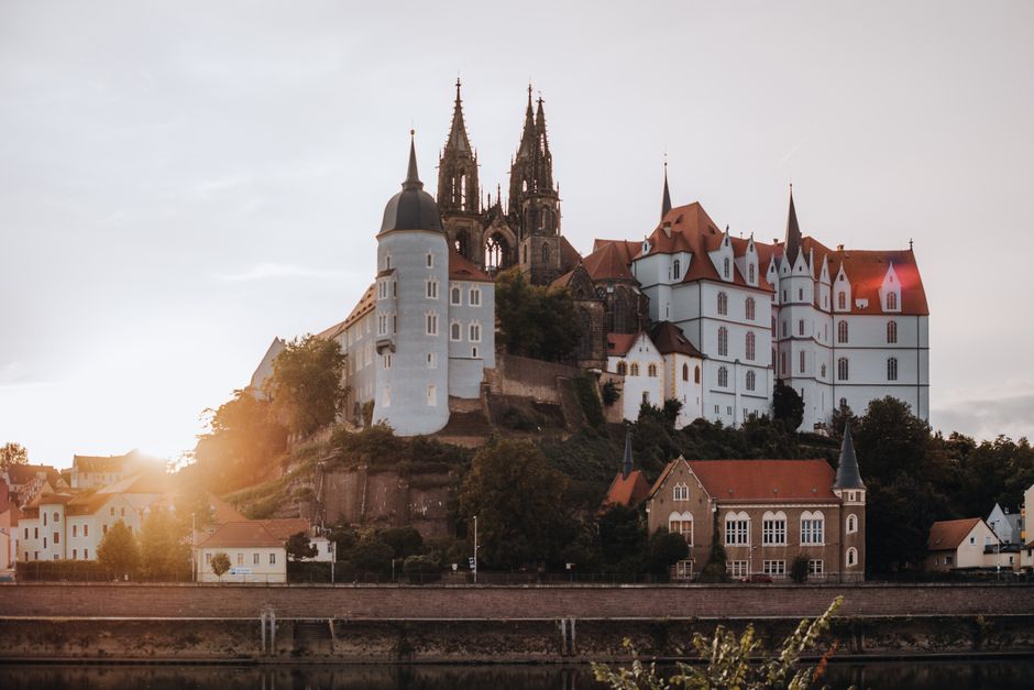 Scenic view of Albrechtsburg Castle in Meissen, Germany during sunset, showcasing historic architecture.